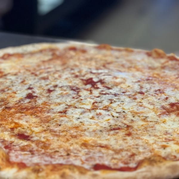 Close-up of a freshly baked La Famiglia cheese pizza, with melted mozzarella and tomato sauce.